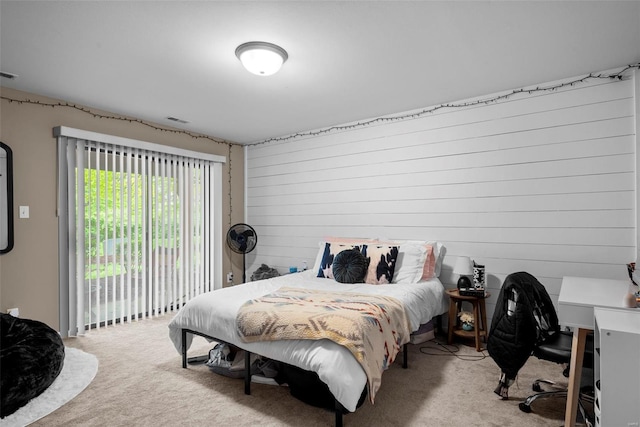 carpeted bedroom with access to outside and visible vents