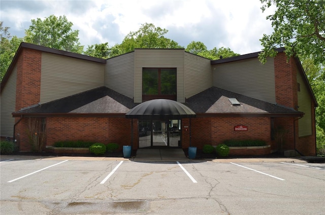 view of building exterior with uncovered parking