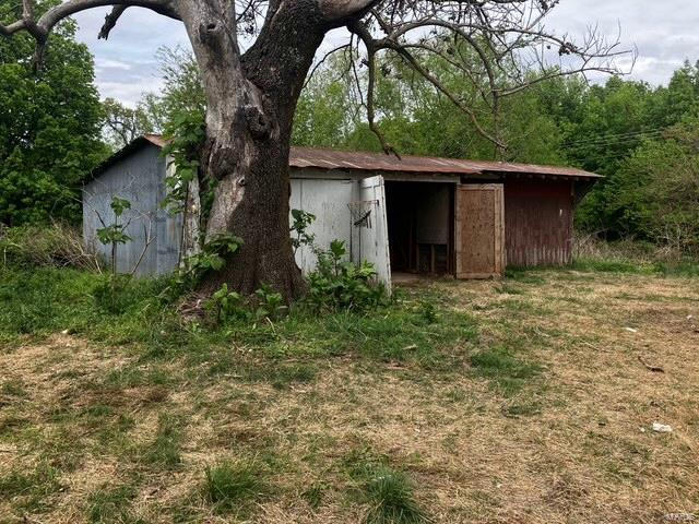 back of property with an outbuilding