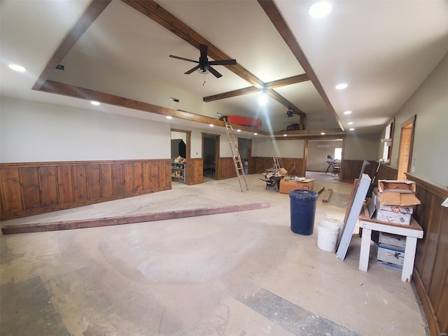 miscellaneous room featuring wooden walls, concrete flooring, wainscoting, a ceiling fan, and recessed lighting