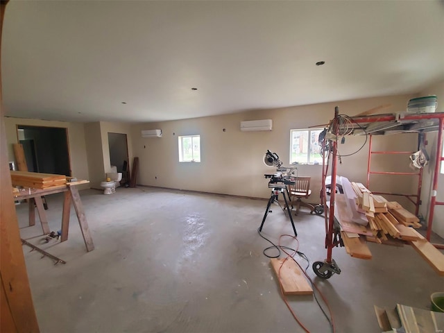 below grade area with an AC wall unit and a wall mounted AC