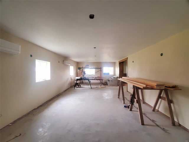 dining area with concrete flooring and an AC wall unit