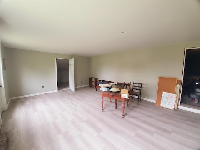 dining room featuring baseboards and light wood finished floors