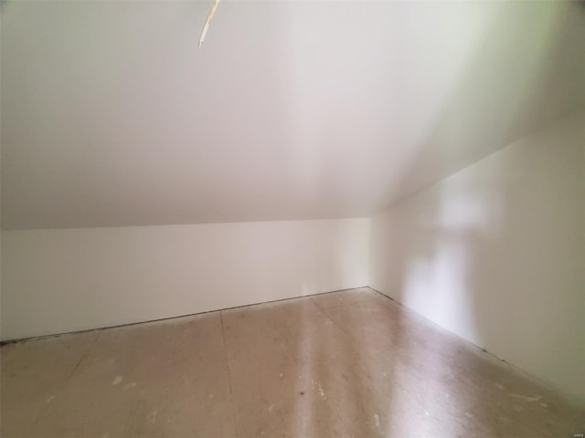 bonus room with concrete flooring and lofted ceiling