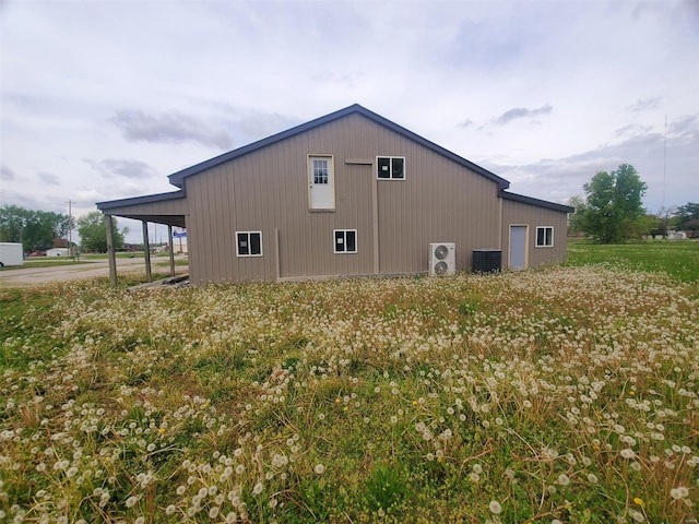 view of home's exterior with central air condition unit and an attached carport