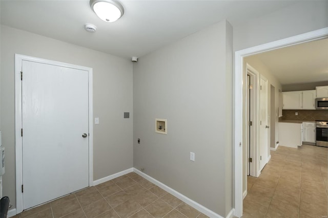 laundry room with hookup for an electric dryer, laundry area, light tile patterned floors, baseboards, and hookup for a washing machine