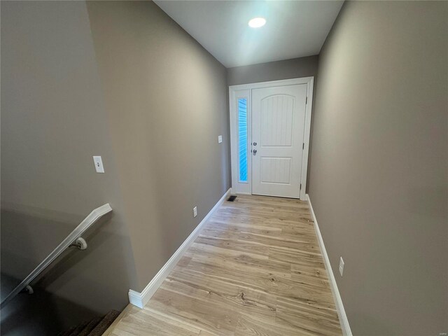 entryway featuring baseboards, visible vents, and light wood-type flooring
