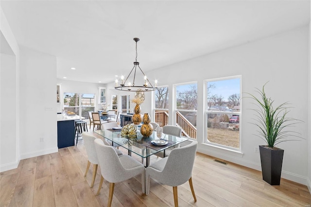 dining room featuring an inviting chandelier, recessed lighting, light wood finished floors, and baseboards