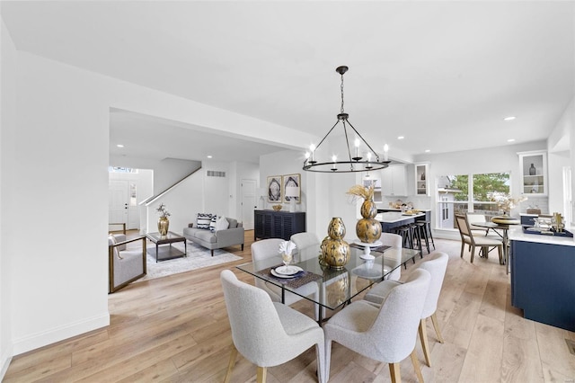 dining space featuring visible vents, baseboards, a chandelier, light wood-style floors, and recessed lighting