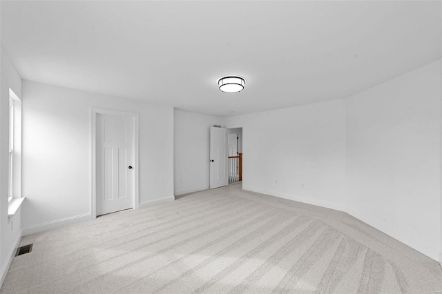 unfurnished bedroom with baseboards, visible vents, and light colored carpet