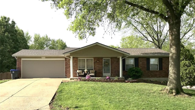 ranch-style house featuring roof with shingles, brick siding, a front lawn, concrete driveway, and an attached garage