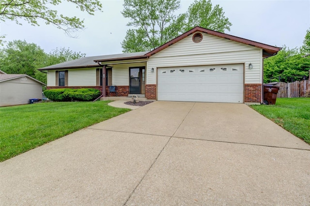 ranch-style home featuring concrete driveway, brick siding, a front lawn, and a garage