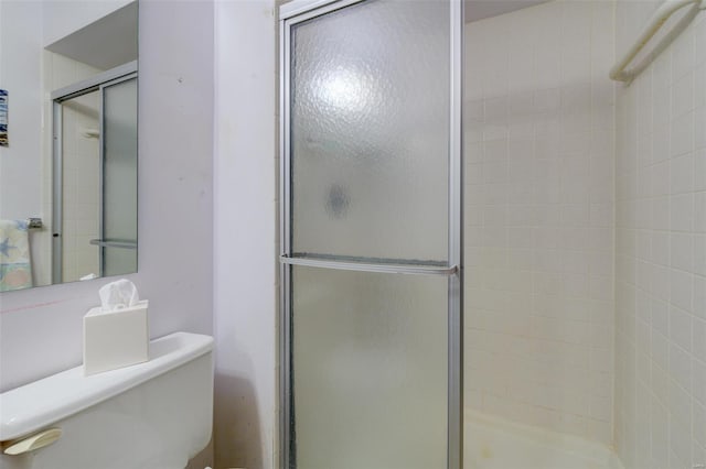 full bath with a stall shower and toilet