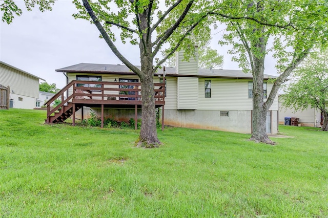 back of house featuring a lawn, a chimney, stairway, and a wooden deck