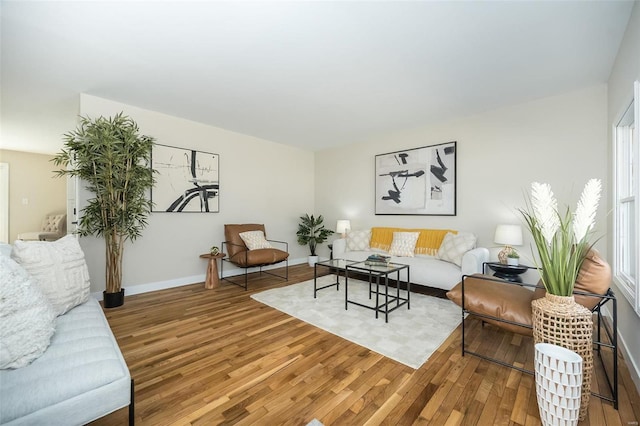 living area with baseboards and light wood finished floors