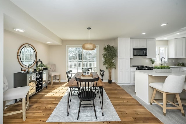 dining space featuring recessed lighting, a healthy amount of sunlight, and light wood-style flooring