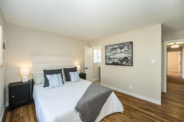 bedroom with baseboards and wood finished floors