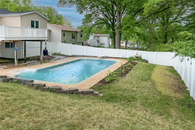 view of swimming pool with a lawn, a fenced in pool, a fenced backyard, and a wooden deck