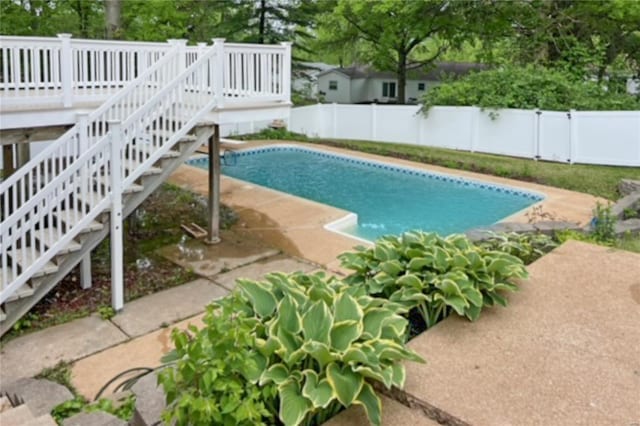 view of pool featuring stairs, a fenced backyard, and a fenced in pool