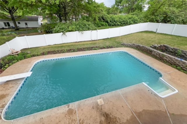 view of swimming pool featuring a lawn, a fenced in pool, and a fenced backyard