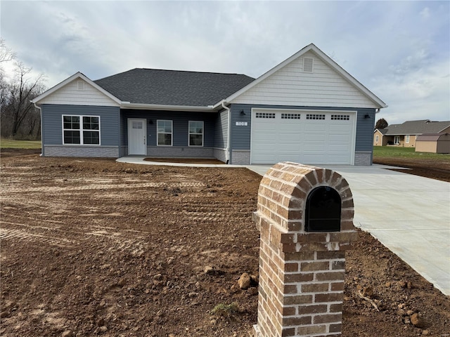 ranch-style home featuring driveway, a shingled roof, and a garage