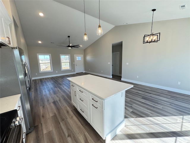 kitchen with dark wood-style flooring, open floor plan, visible vents, and vaulted ceiling
