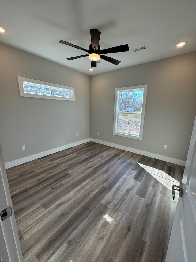 empty room featuring wood finished floors, visible vents, recessed lighting, ceiling fan, and baseboards