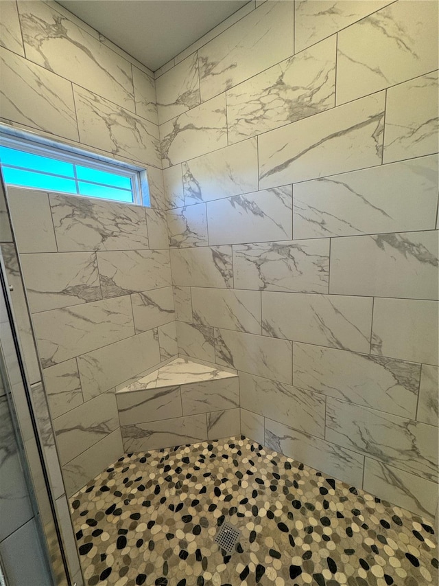 bathroom with tiled shower