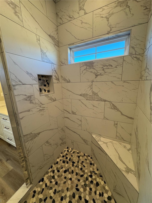 bathroom with a tile shower