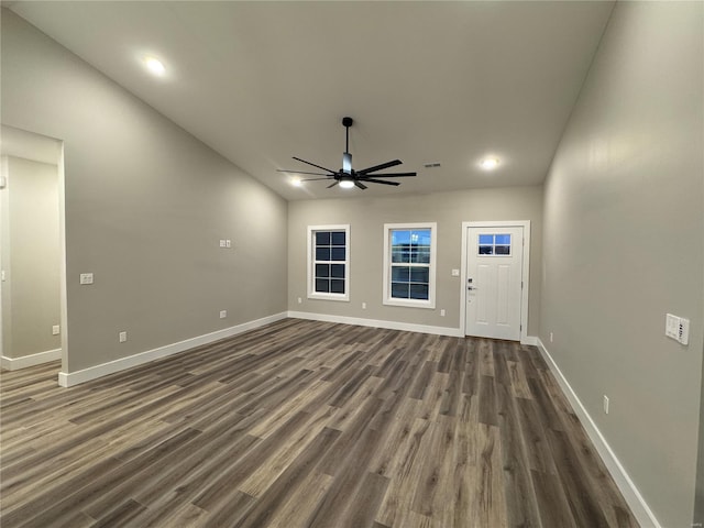 unfurnished living room with dark wood-type flooring, baseboards, a ceiling fan, and recessed lighting