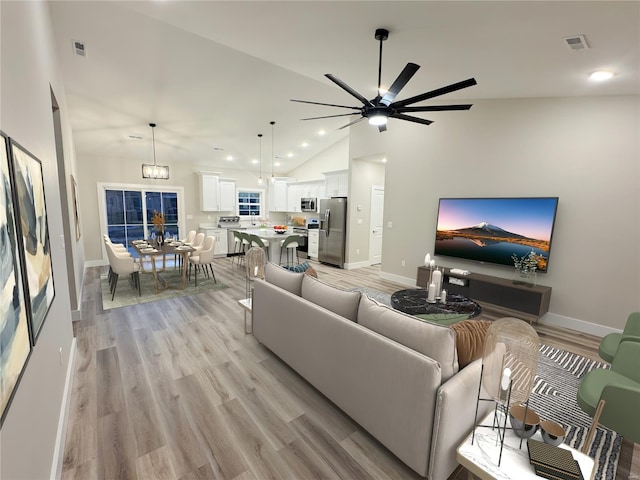 living area with ceiling fan, baseboards, and visible vents