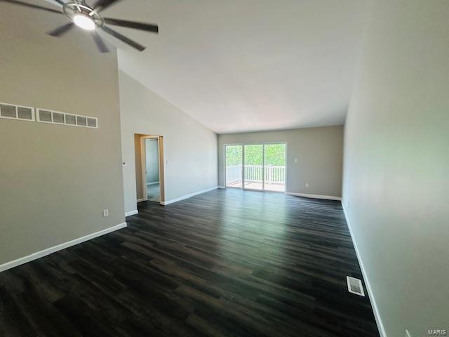 empty room with baseboards, dark wood-type flooring, ceiling fan, and visible vents
