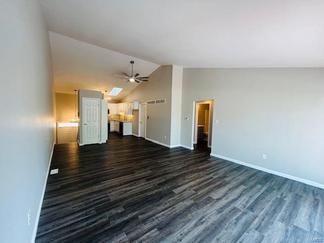 unfurnished living room with visible vents, baseboards, a ceiling fan, dark wood finished floors, and vaulted ceiling
