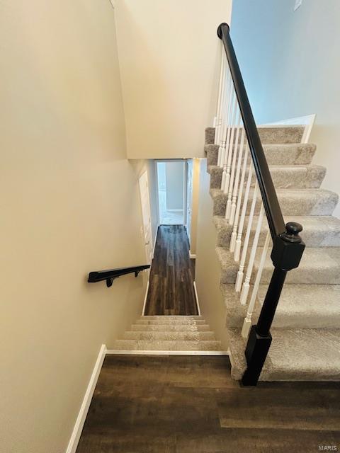 stairs featuring baseboards and wood finished floors