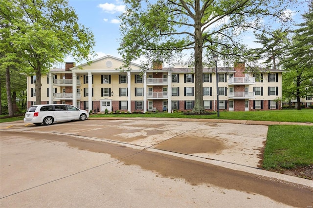 view of building exterior featuring uncovered parking