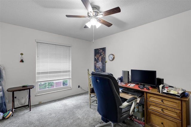 office with a textured ceiling, ceiling fan, baseboards, and carpet