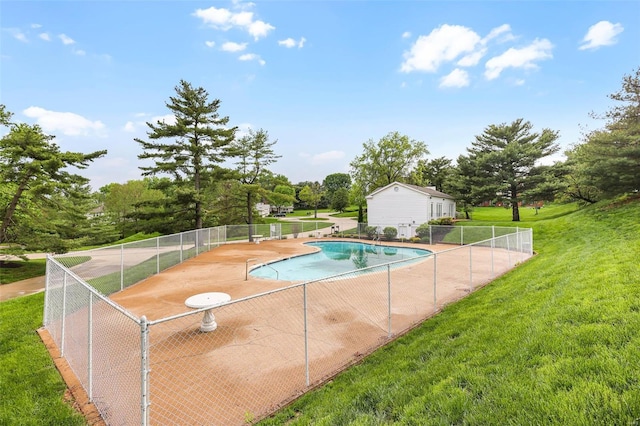 pool with a lawn, fence, and a patio