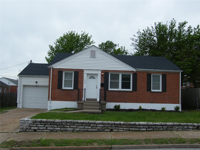 view of front of house with fence, an attached garage, concrete driveway, and brick siding
