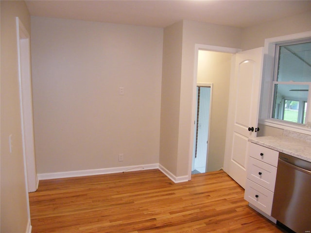 empty room with baseboards and light wood-style flooring