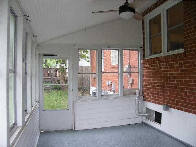 unfurnished sunroom with ceiling fan