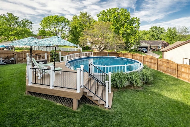 view of swimming pool featuring a fenced in pool, a fenced backyard, a wooden deck, and a yard