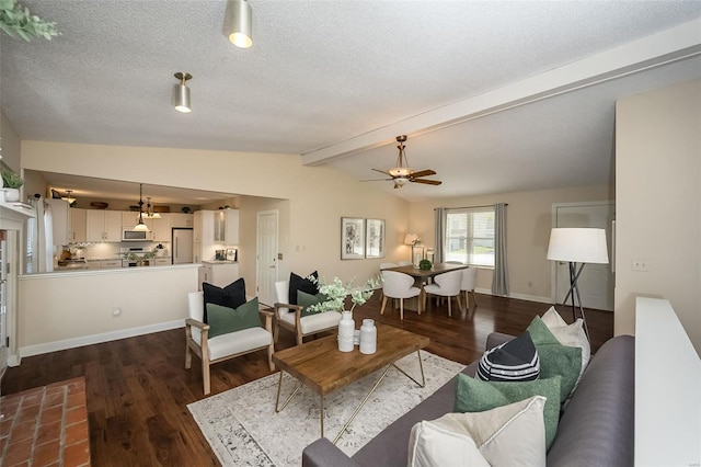 living area with vaulted ceiling with beams, a textured ceiling, dark wood-type flooring, and ceiling fan
