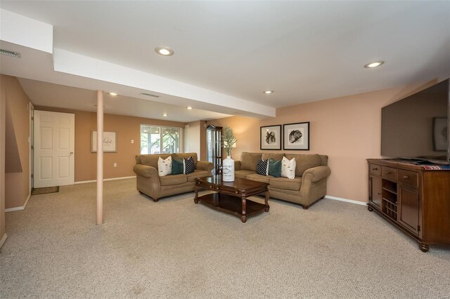 living room featuring light colored carpet, recessed lighting, baseboards, and visible vents