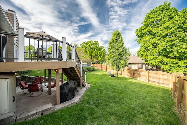 view of yard featuring stairway, a fenced backyard, and a patio area