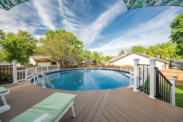 view of pool with a fenced backyard, a fenced in pool, and a deck