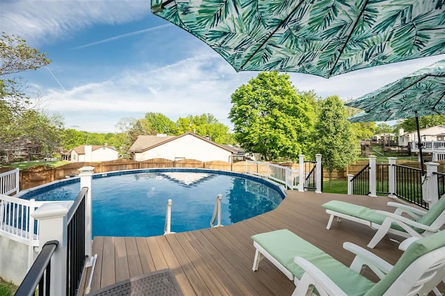 view of pool featuring a fenced in pool, a fenced backyard, and a deck