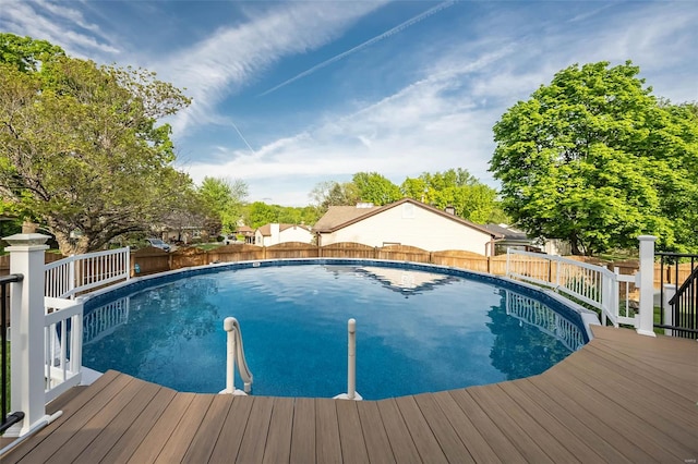 view of swimming pool with a fenced in pool, a wooden deck, and a fenced backyard
