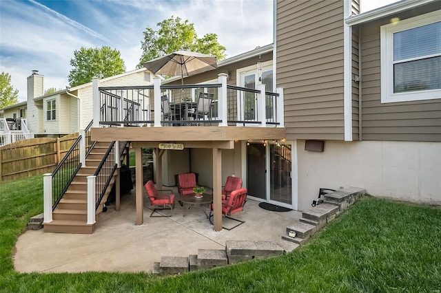 rear view of house featuring stairway, a patio, fence, and a wooden deck