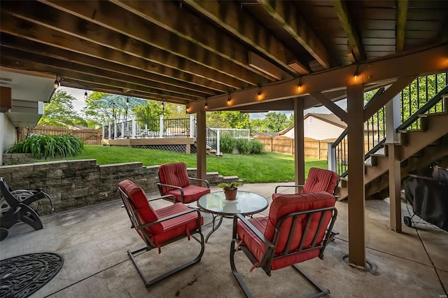 view of patio with stairs, a fenced backyard, and a deck