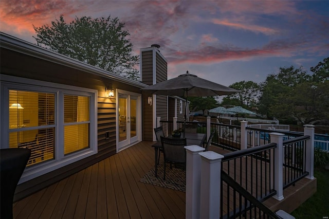 wooden deck featuring french doors and outdoor dining area